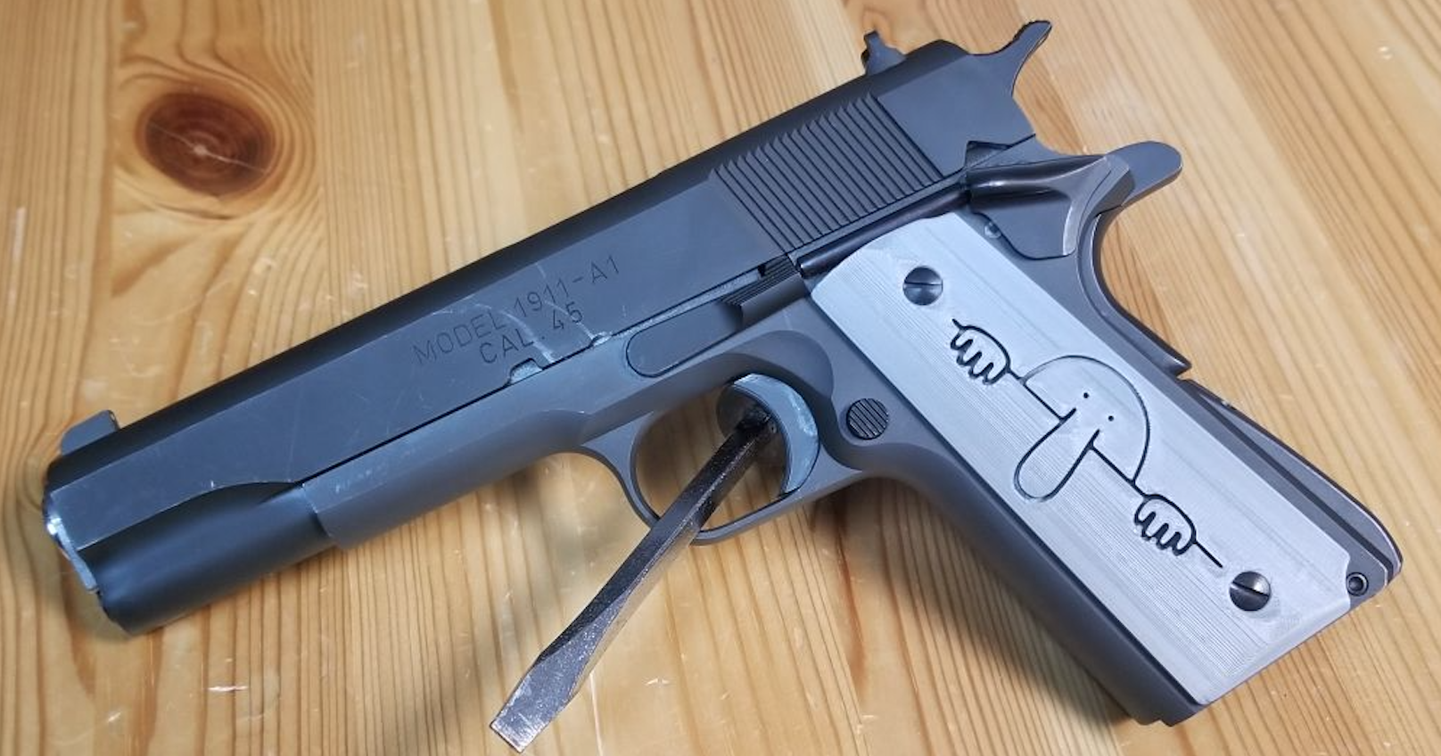 A 1911 Springfield with the 'Killroy' custom 3D printed grips by FFFTech